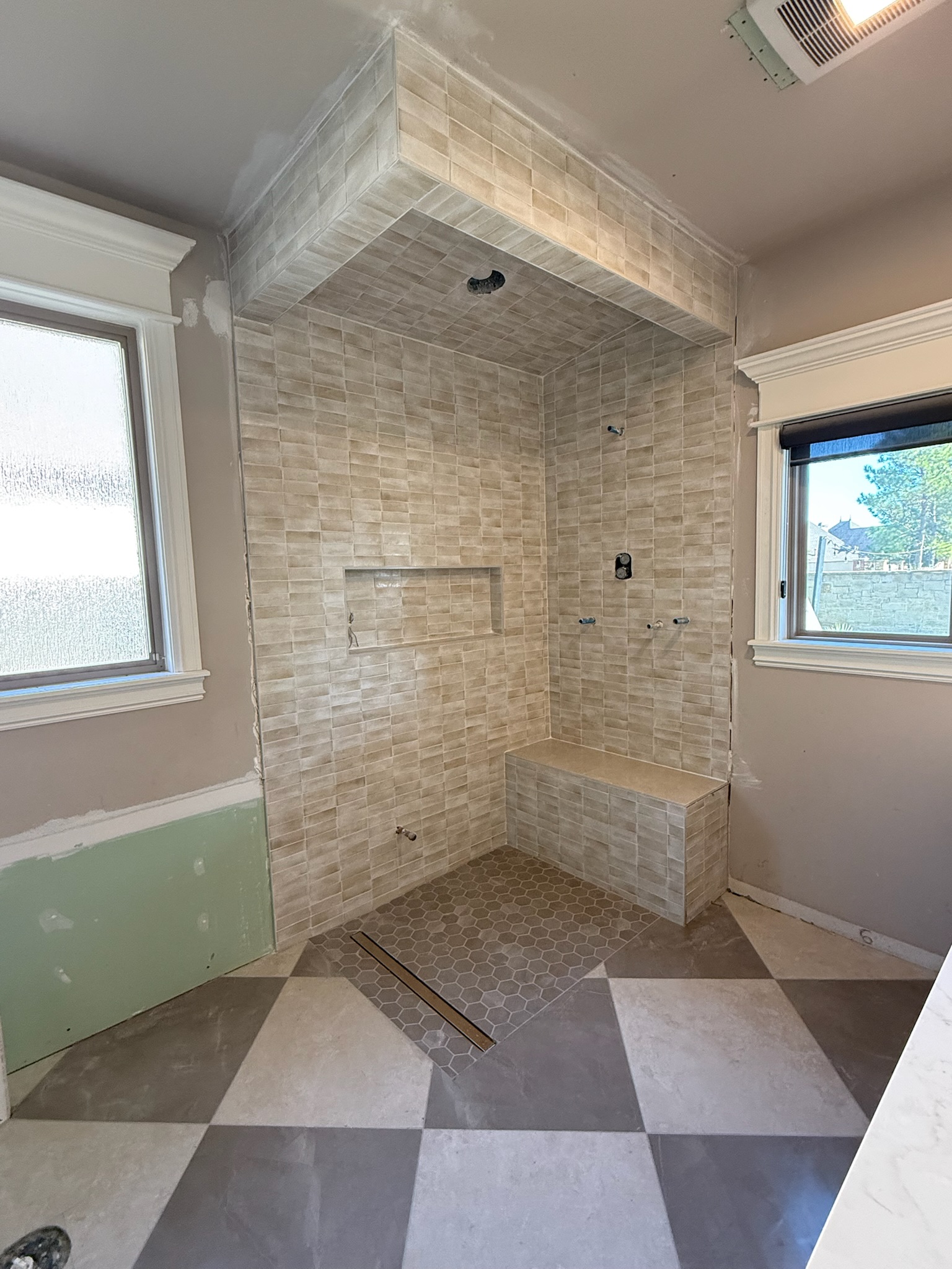 Custom tile shower installation with bench and niche in Tulsa by Reyna Tile & Flooring