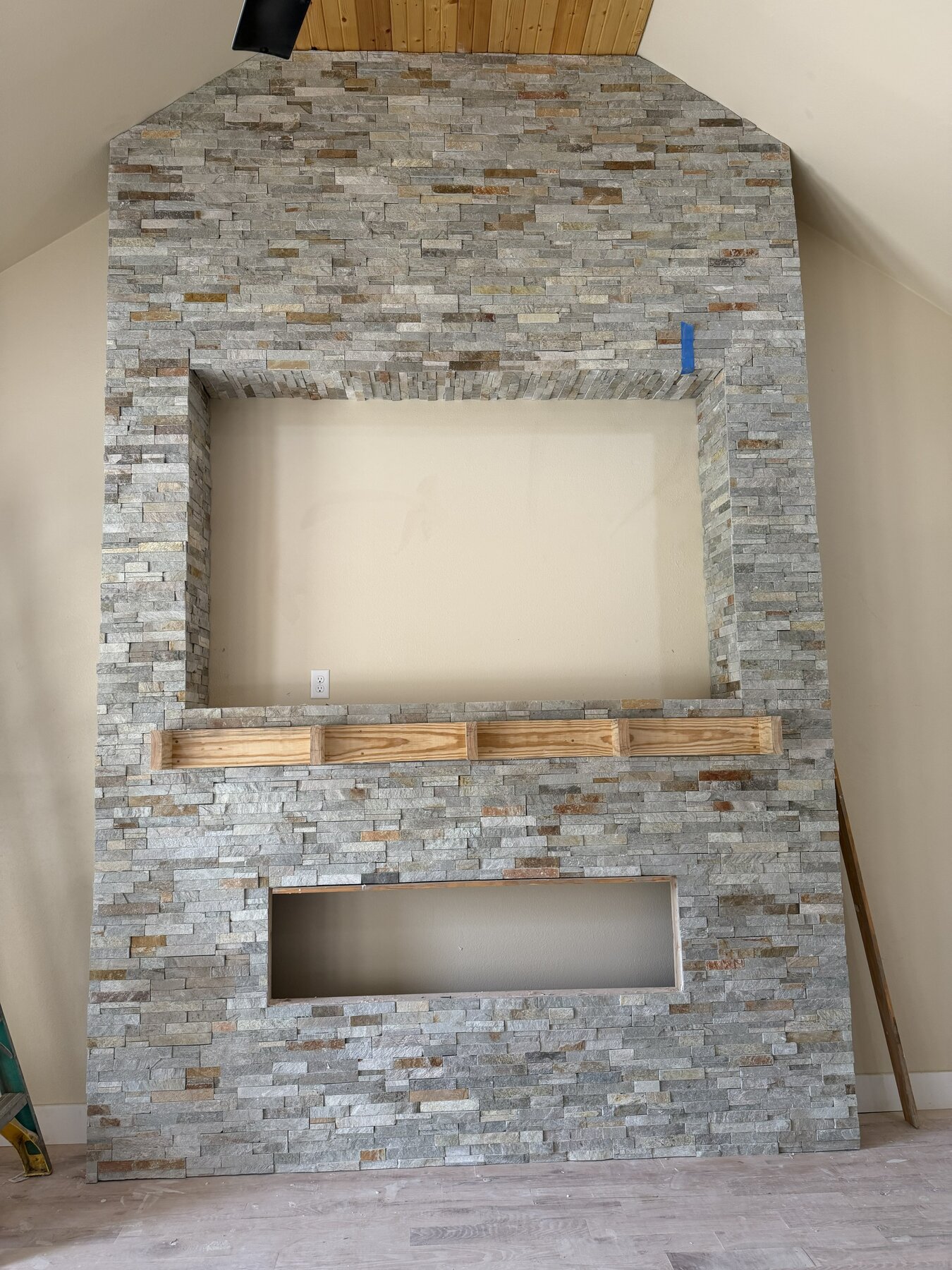 Stacked stone fireplace tile installation with TV niche and mantel cutouts — Tulsa, OK